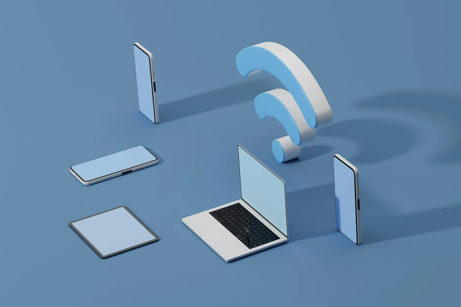 Tablet, phone, and laptop on blue surface with Wi-Fi symbol.
